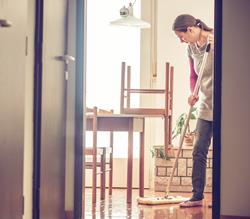 woman dust mopping floor